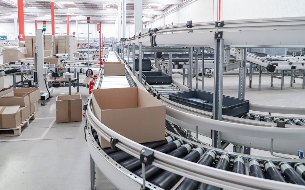 Open box moving along a fulfillment center conveyor